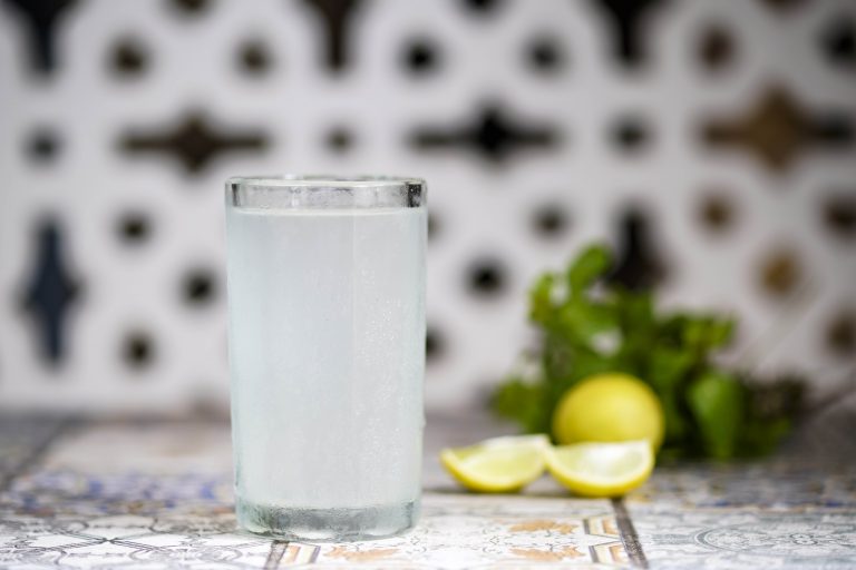 A glass of nimbu pani with mint